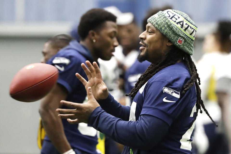 Seattle Seahawks running back Marshawn Lynch catches a football as he warms up for NFL football practice, Friday, Dec. 27, 2019, in Renton, Wash. The Seahawks will face the San Francisco 49ers Sunday, Dec. 29, 2019 in Seattle. (AP Photo/Ted S. Warren)