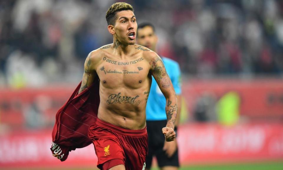 Roberto Firmino celebrates his winner against Flamengo by taking off his shirt