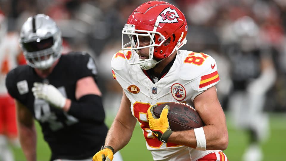 Travis Kelce runs with the ball (and, presumably, Taylor Swift's heart) during the second quarter against the Las Vegas Raiders on November 26. - Candice Ward/Getty Images