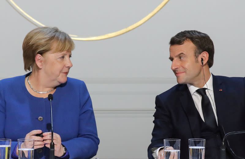 FILE PHOTO: German Chancellor Angela Merkel and French President Emmanuel Macron give a news conference after a meeting in Paris