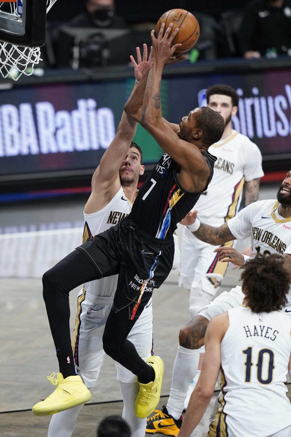 Brooklyn Nets' Kevin Durant (7) shoots over New Orleans Pelicans' Willy Hernangomez during the first half of an NBA basketball game Wednesday, April 7, 2021, in New York. (AP Photo/Frank Franklin II)