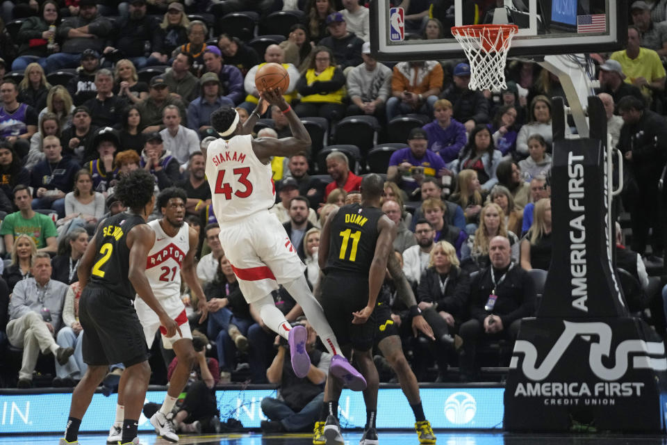 Toronto Raptors forward Pascal Siakam (43) shoots over Utah Jazz guard Kris Dunn (11) during the first half of an NBA basketball game Friday, Jan. 12, 2024, in Salt Lake City. (AP Photo/Rick Bowmer)