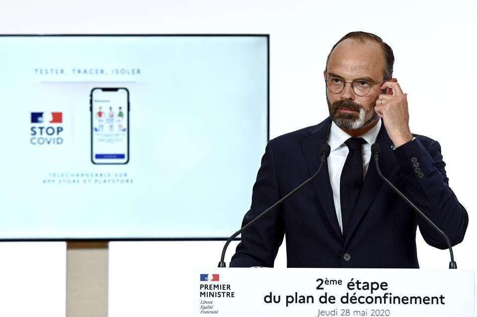 French Prime Minister Edouard Philippe speaks during a televised address next to a screen showing the future in Paris Thursday, May 28, 2020. France is reopening its restaurants, bars and cafes starting next week as the country eases most restrictions amid the coronavirus crisis. Edouard Philippe defended the gradual lifting of lockdown up to now, saying the strategy was meant to avoid provoking a second wave. French lawmakers approved France's contact-tracing app designed to contain the spread of the coronavirus. (Philippe Lopez, Pool via AP)