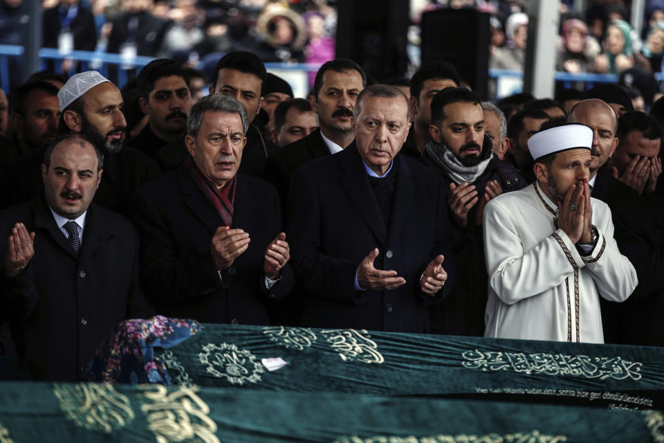 Turkey's President Recep Tayyip Erdogan, center, joins hundreds of mourners who attend the funeral prayers for nine members of Alemdar family killed in a collapsed apartment building, in Istanbul, Saturday, Feb. 9, 2019. Erdogan says there are "many lessons to learn" from the collapse of a residential building in Istanbul where at least 17 people have died.(AP Photo/Emrah Gurel)