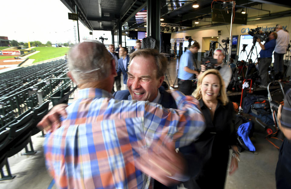 Michigan Attorney General Bill Schuette and his family greet supporter Jim Barrett before the polls close on primary election day, Tuesday, Aug 7, 2018, in Midland, Mich. Schuette's post-election event is being held at Dow Diamond, the home of Midland's minor league baseball team. (Dale G. Young/Detroit News via AP)