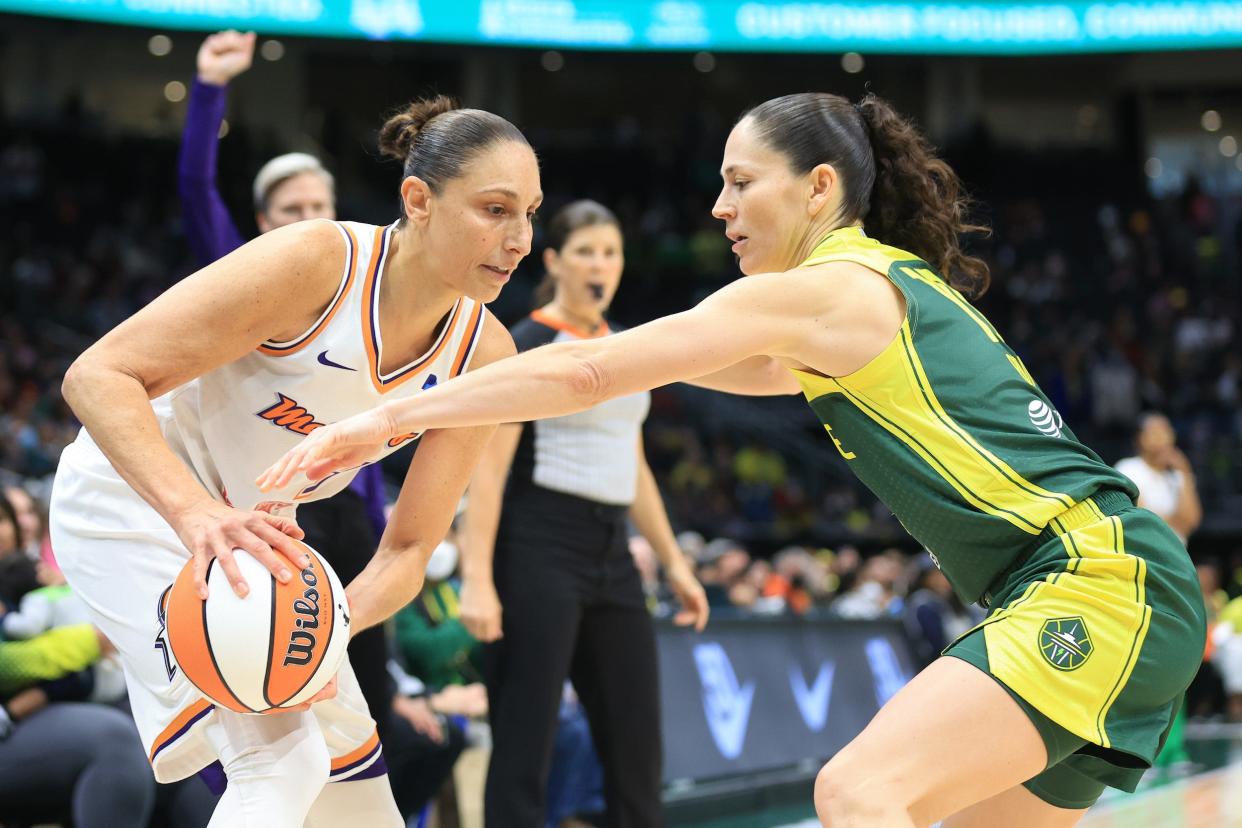 Sue Bird (right) defends against Diana Taurasi.