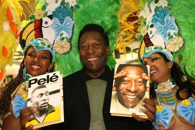 Pele, centre, promotes his autobiography with Brazilian dancers at Easons Bookstore, Dublin in May 2006
