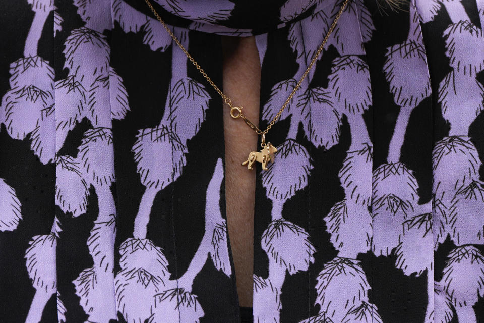 A woman wears a dog necklace at the 148th Westminster Kennel Club Dog show, Monday, May 13, 2024, at the USTA Billie Jean King National Tennis Center in New York. (AP Photo/Julia Nikhinson)