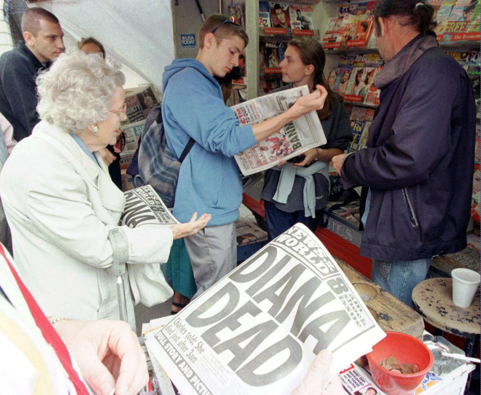 FILE - People buy Sunday newspapers reporting the death of Diana, Princess of Wales, in London, Sunday Aug. 31, 1997. The story of Princess Diana's death at age 36 in that catastrophic crash in a Paris traffic tunnel continues to shock, even a quarter-century later. (AP Photo/Adrian Dennis, File)