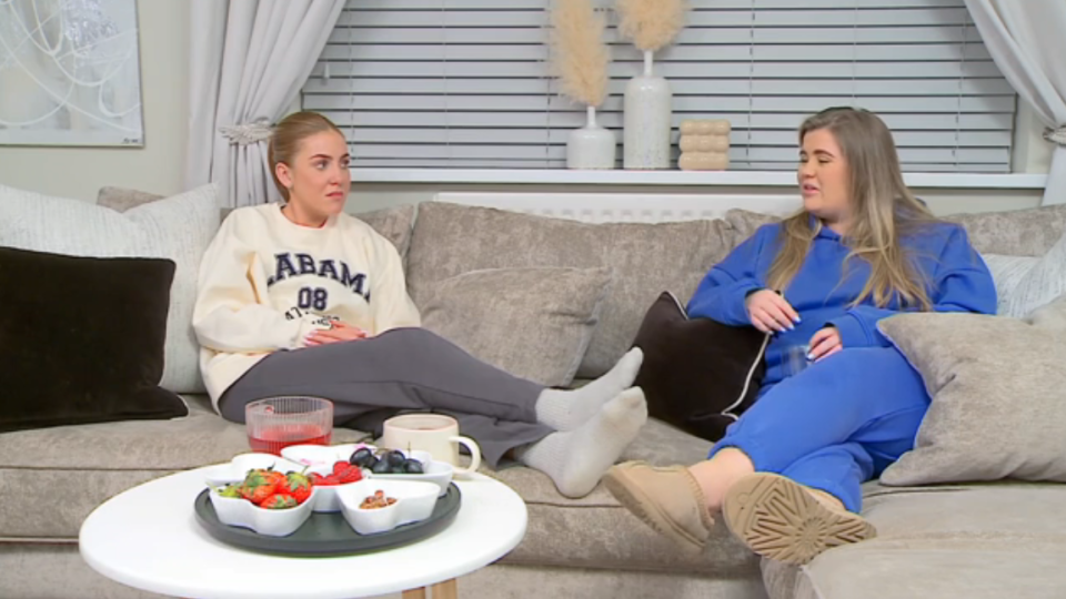 a couple of women sitting on a couch