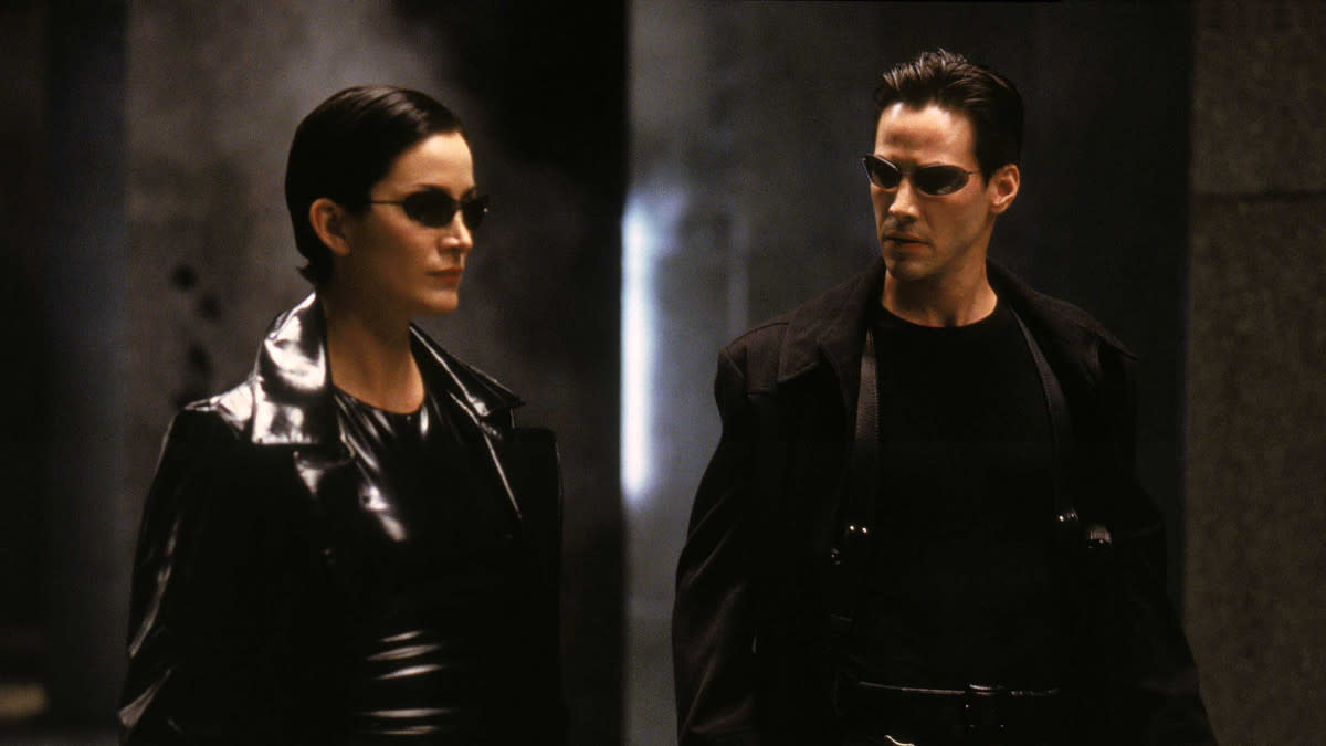 Carrie-Anne Moss as Trinity and Keanu Reeves as Neo in the 'Matrix' franchise. (Credit: Warner Bros)