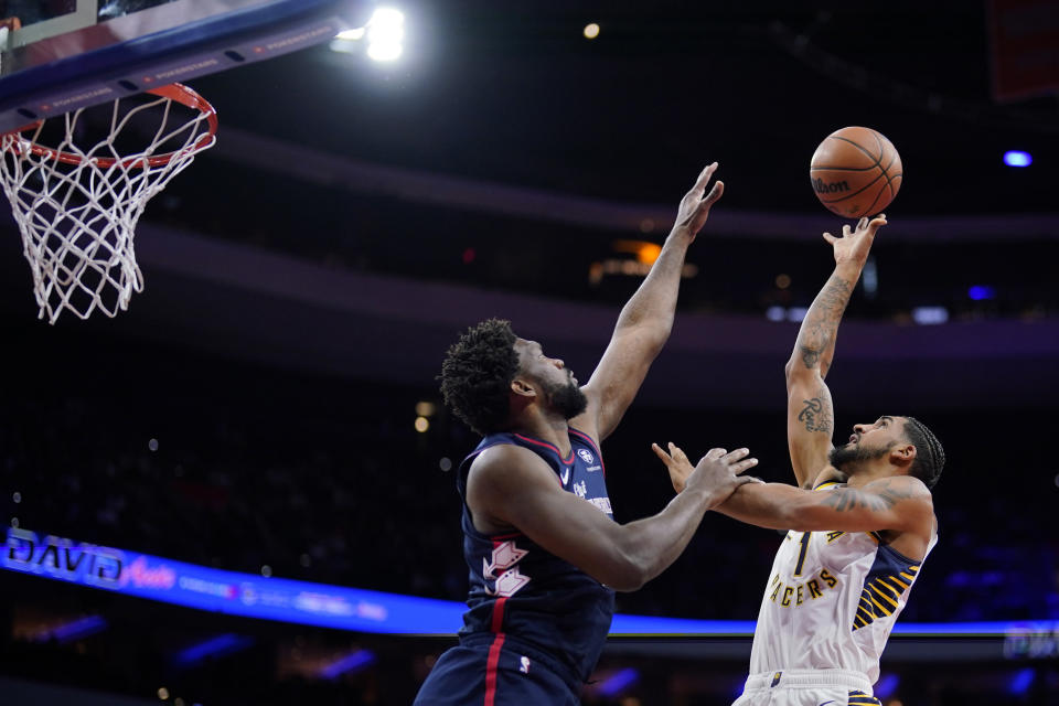 Indiana Pacers' Obi Toppin, right, tries to get a shot past Philadelphia 76ers' Joel Embiid during the first half of an NBA basketball in-season tournament game, Tuesday, Nov. 14, 2023, in Philadelphia. (AP Photo/Matt Slocum)
