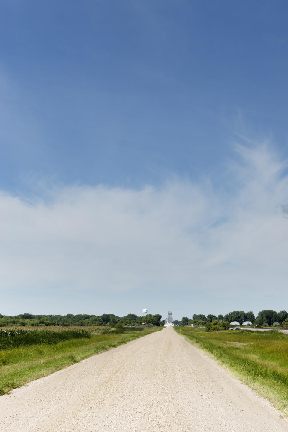 dirt road with fields surrounding