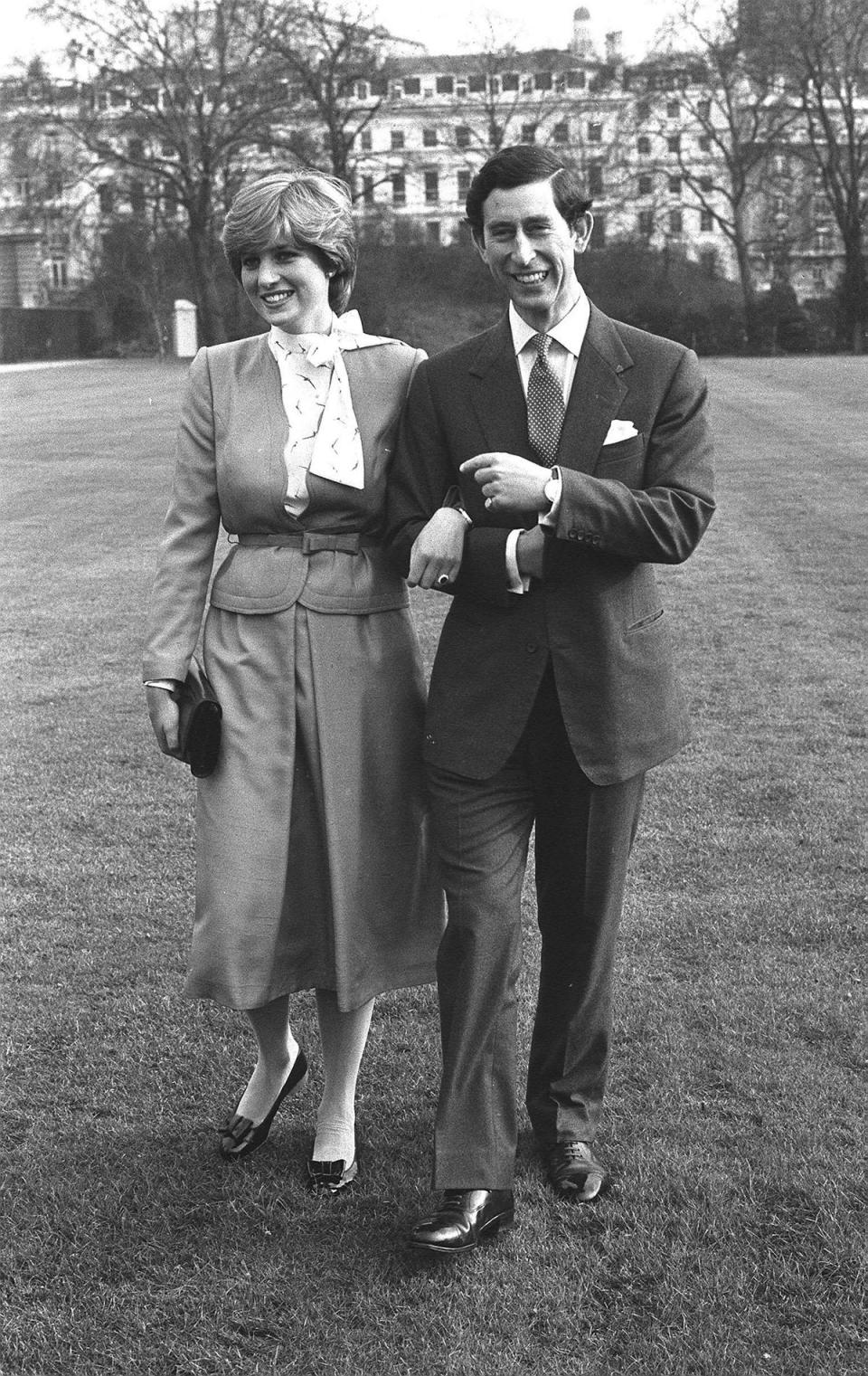 Charles and Diana walking arm-in-arm at Buckingham Palace after announcing their engagement in 1981 (PA Archive)