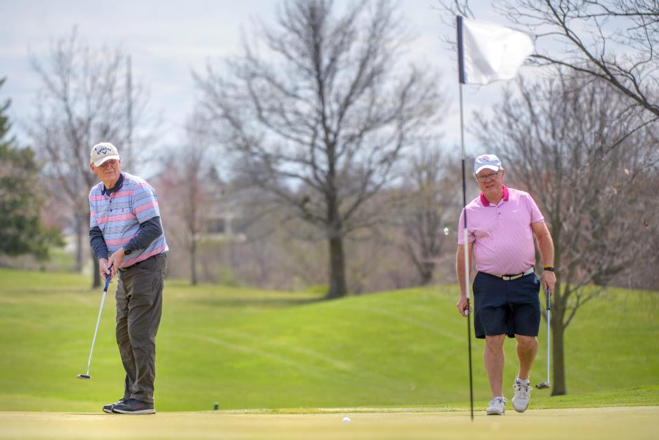 Mike Blanco, right, of Peoria watches as Bill Dutton of East Peoria drops a birdie putt on No. 5 during the Peoria Park District Spring Swing event Wednesday, April 9, 2024 at Kellogg Golf Course in Peoria.