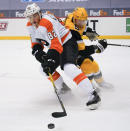 Philadelphia Flyers' Connor Bunnaman (82) controls the puck in front of Pittsburgh Penguins' Mike Matheson (5) during the second period of an NHL hockey game Thursday, March 4, 2021, in Pittsburgh. (AP Photo/Keith Srakocic)