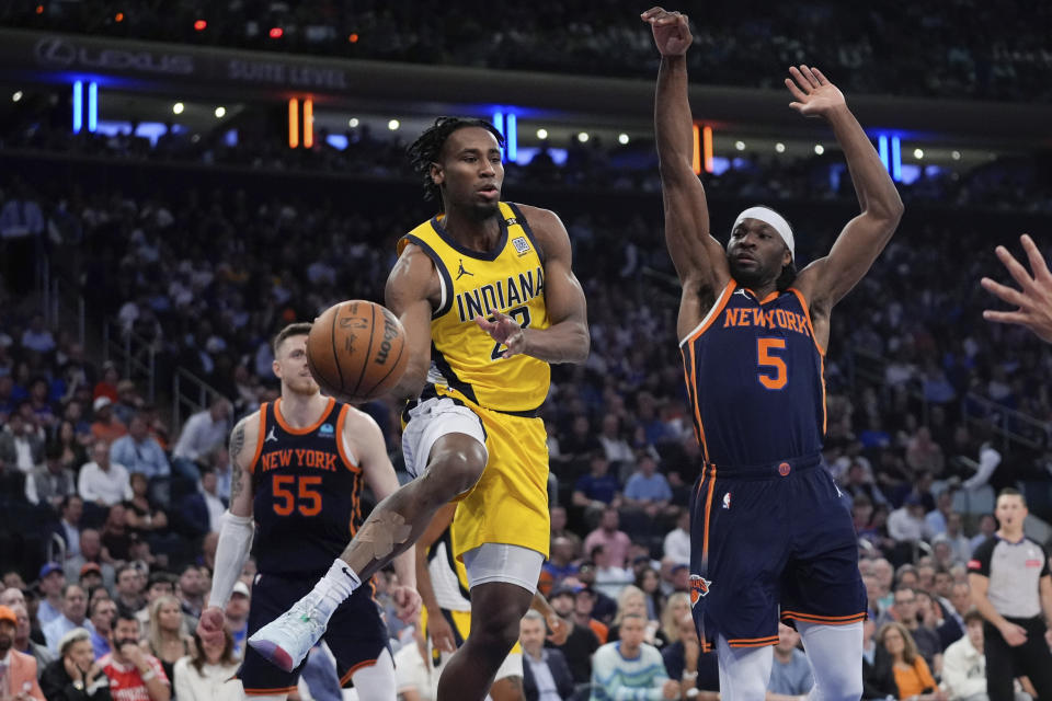 Indiana Pacers' Aaron Nesmith (23) passes the ball away from New York Knicks' Precious Achiuwa (5) during the first half of Game 2 in an NBA basketball second-round playoff series Wednesday, May 8, 2024, in New York. (AP Photo/Frank Franklin II)