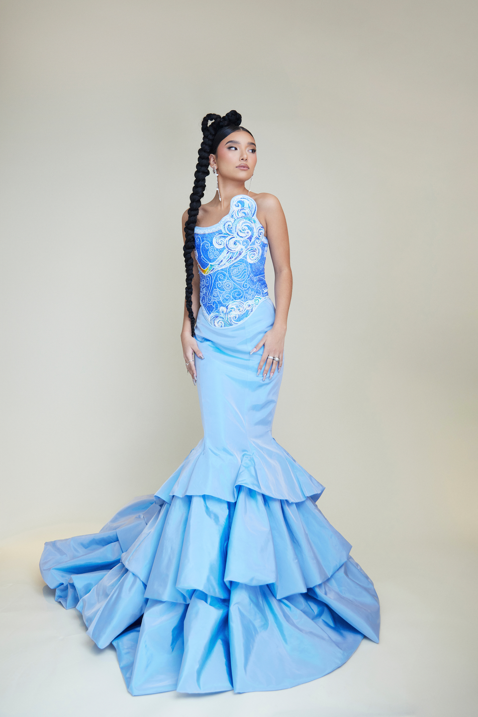 actress kiawentiio posing in a blue mermaid gown with her eyes looking off camera