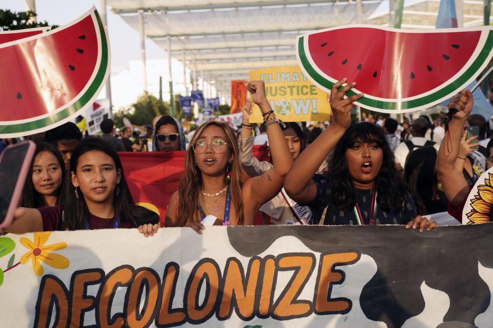 Mitzi Jonelle Tan, of the Philippines, center, and activists demonstrate for climate justice and a ceasefire in the Israel-Hamas war at the COP28 U.N. Climate Summit, Saturday, Dec. 9, 2023, in Dubai, United Arab Emirates. (AP Photo/Rafiq Maqbool)