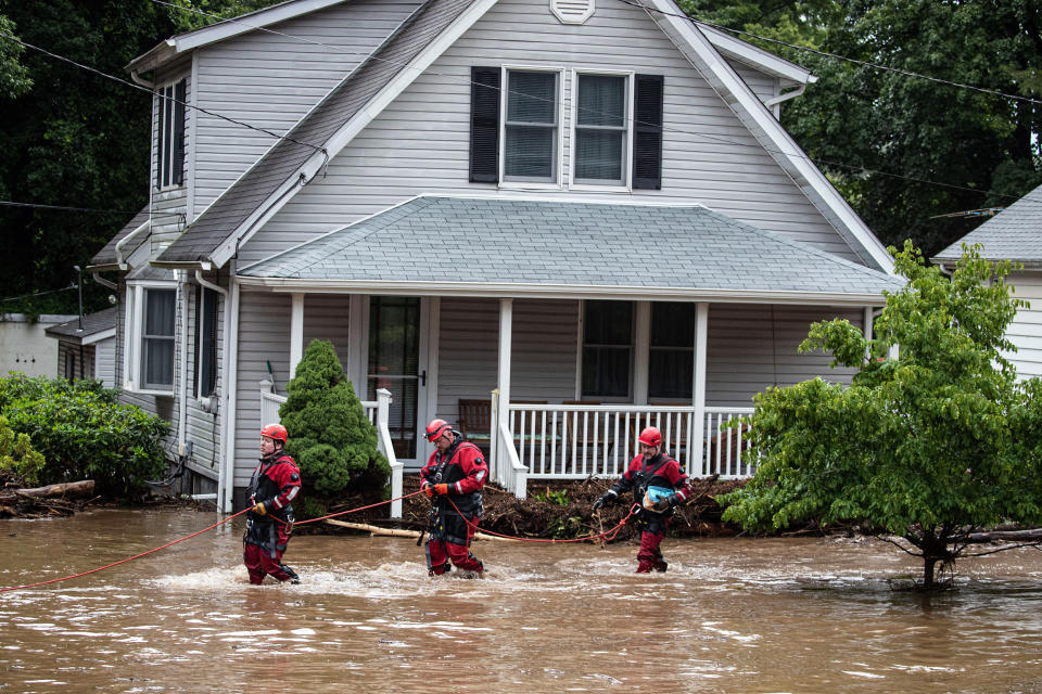 Emergency personnel work at the scene of flooded homes in Stony Point, N.Y. (Seth Harrison / USA Today Network )