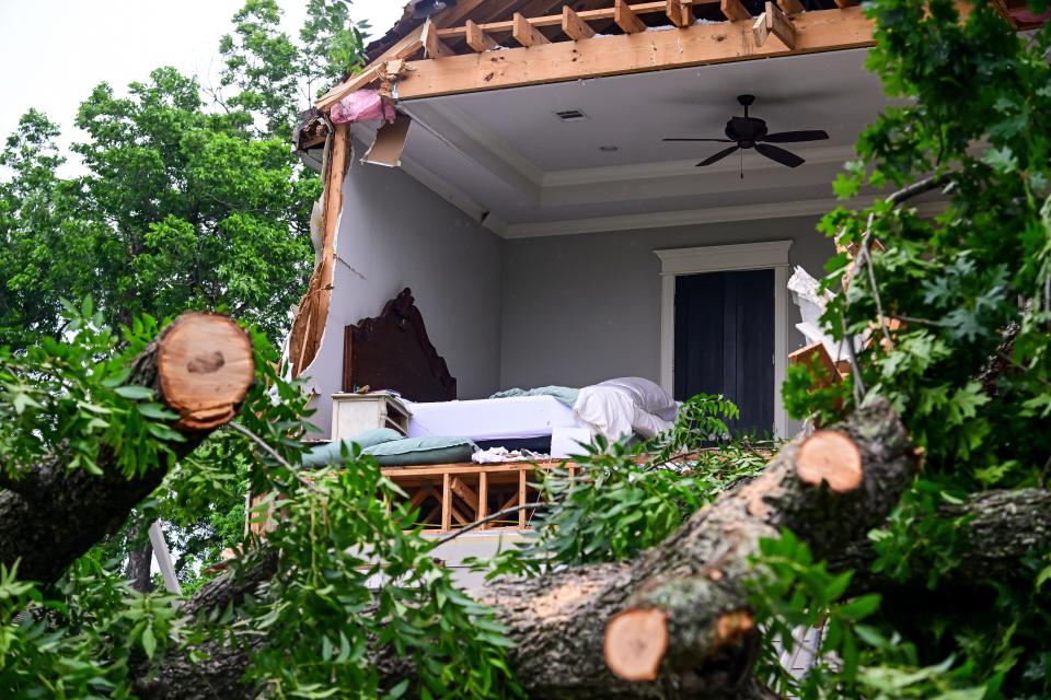 A home is severely damaged by a fallen tree after heavy winds and rains ripped through the region on May 17, 2024 in Houston.