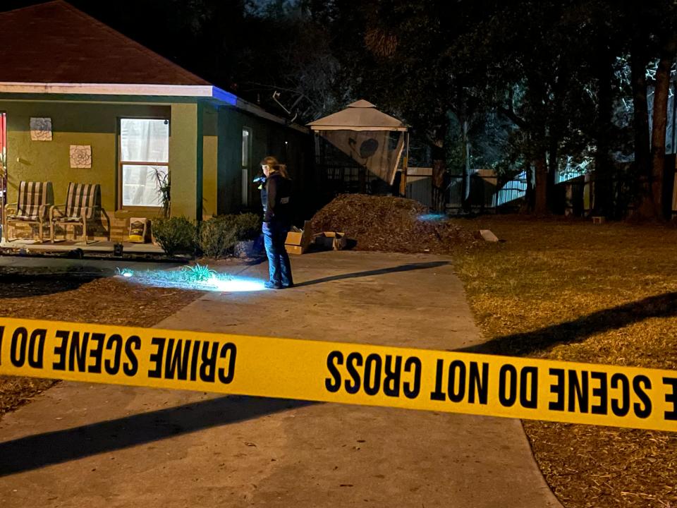 A crime scene technician works at the scene of the January 2022 shooting where Ferron Williams was killed.