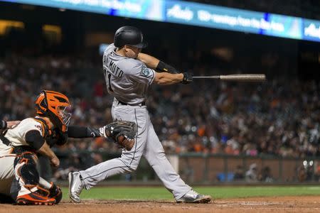 Jun 18, 2018; San Francisco, CA, USA; Miami Marlins catcher J.T. Realmuto (11) hits an RBI single against the San Francisco Giants in the ninth inning at AT&T Park. Mandatory Credit: John Hefti-USA TODAY Sports