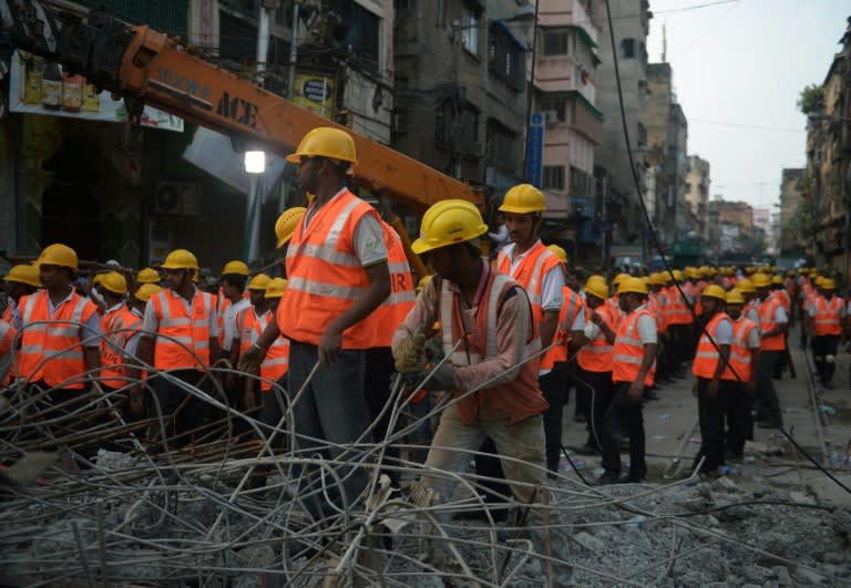 Rescue workers attempt to free people trapped under the wreckage of a collapsed flyover bridge in Kolkata, on April 1, 2016