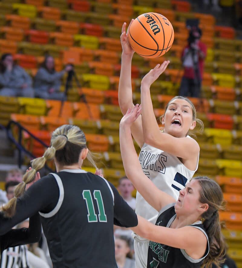 Ridgeline's Emilee Skinner passes the ball as Green Canyon's Marissa Best (11) and Janalynn Blotter defend during a semifinal game in the Utah 4A girls basketball tournament on Thursday in Logan. | Eli Lucero, Herald Journal