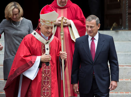 U.S. Supreme Court Chief Justice John Roberts walks with Cardinal Donald Wuerl, archbishop of Washington, after attending the 64th Annual Red Mass at the Cathedral of St. Matthew the Apostle in Washington, U.S., October 2, 2016. REUTERS/Joshua Roberts/Files