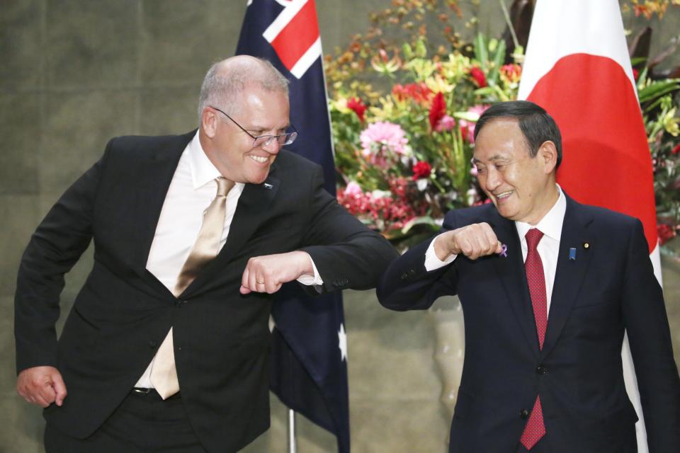 New Japanese Prime Minister Yoshihide Suga greets Australian PM Scott Morrison in Tokyo on Tuesday. Source: AAP