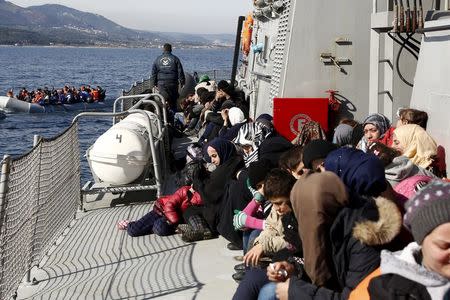 Refugees and migrants are seen aboard the Ayios Efstratios Coast Guard vessel following a rescue operation at open sea between the Turkish coast and the Greek island of Lesbos, February 8, 2016. REUTERS/Giorgos Moutafis