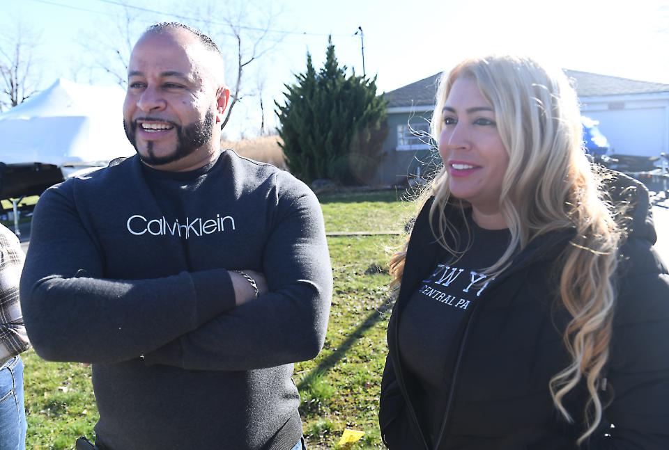 Mike and Lissette Rodriguez on Saturday discuss the upcoming solar eclipse April 8, 2024, near their Edgemere Drive home in the town of Greece, New York.