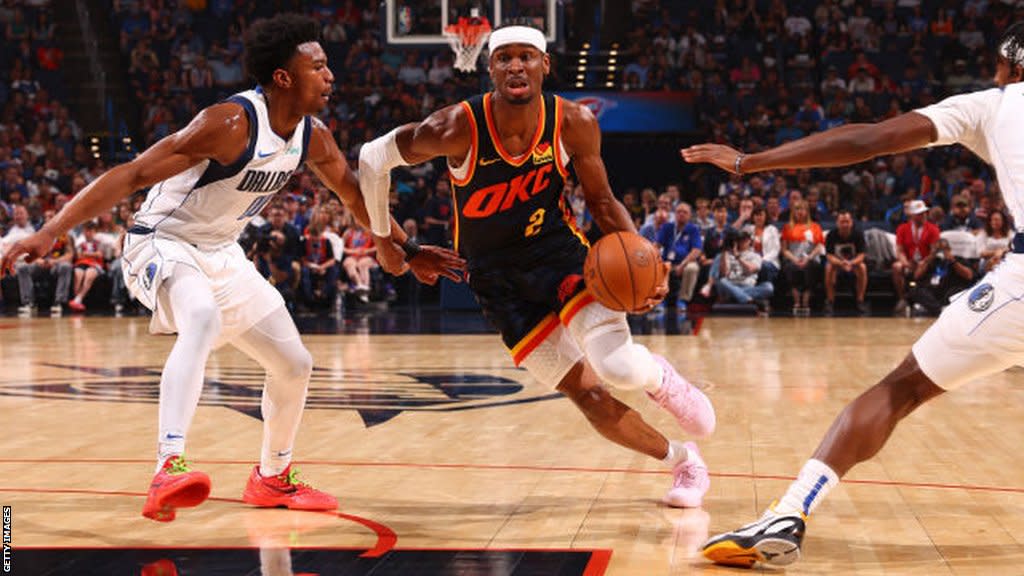 Shai Gilgeous-Alexander dribbles the ball against the Dallas Mavericks