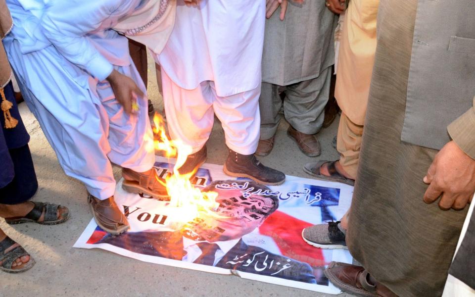 Protesters burned Mr Macron's likeness in Quetta, Pakistan -  JAMAL TARAQAI/EPA-EFE/Shutterstock