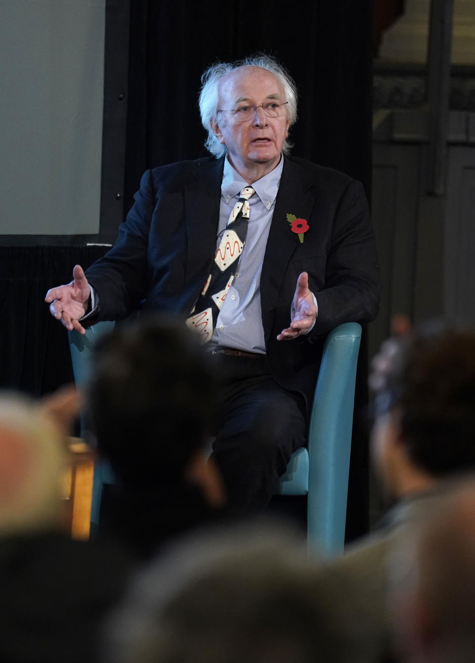 Sir Philip Pullman speaks at the Sheldonian Theatre, Oxford University, England, Thursday Nov. 9, 2023. Fans of Philip Pullman have been waiting almost five years for the final instalment in the author’s sextet of books about his intrepid heroine Lyra and her adventures in multiple worlds. They won’t have to wait too much longer. Pullman says he has written 500 pages of a 540-page novel to conclude the “Book of Dust” trilogy, and it should be published next year. He he still doesn’t have a title. (Andrew Matthews/PA via AP)