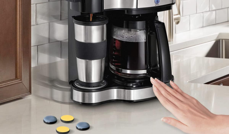 a hand pushing a coffee maker on a counter next to four appliance sliders