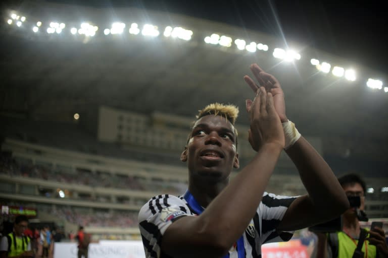 Juventus midfielder Paul Pogba celebrates his team's victory after the Italian Super Cup final against Lazio in Shanghai on August 8, 2015