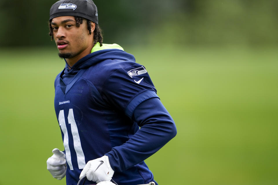 FILE - Seattle Seahawks wide receiver Jaxon Smith-Njigba jogs off the field Monday, May 22, 2023, at the team's NFL football training facility in Renton, Wash. The offense should take steps forward with Geno Smith in charge for a second season and the addition of a weapon like Smith-Njigba. (AP Photo/Lindsey Wasson, FIle)