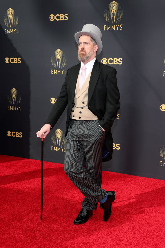 Brendan Hunt on the red carpet in a classic suit, top hat, cane, and tails
