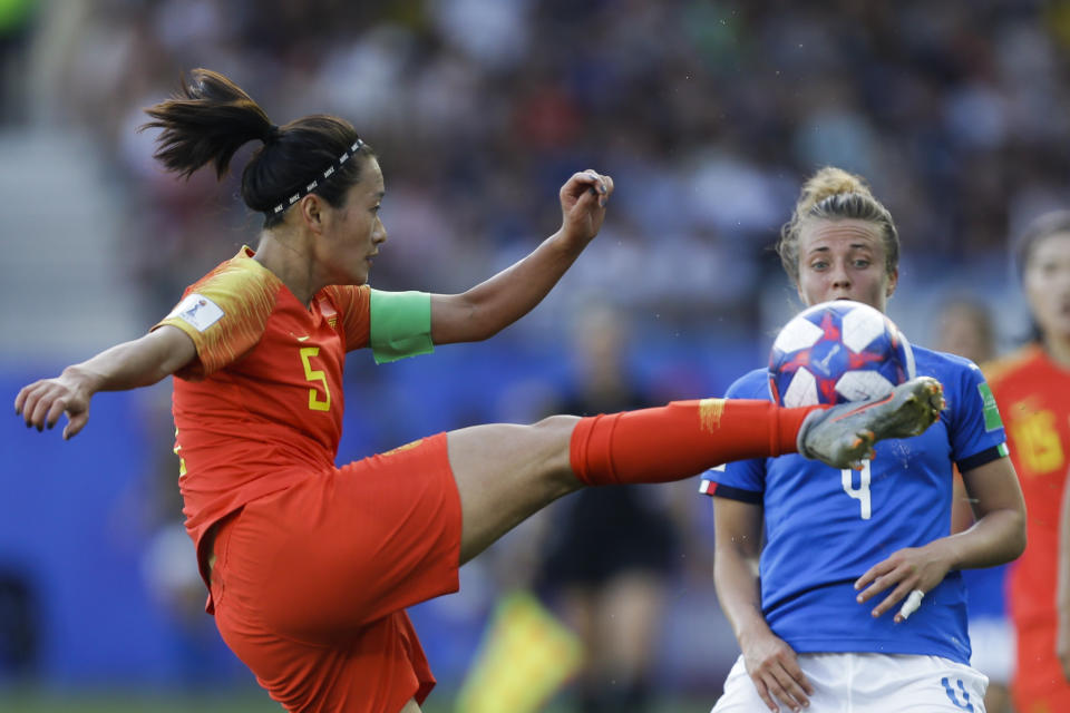 China's Wu Haiyan, left, shoots the ball next to Italy's Aurora Galli during the Women's World Cup round of 16 soccer match between Italy and China at Stade de la Mosson in Montpellier, France, Tuesday, June 25, 2019. Italy won 2-0. (AP Photo/Claude Paris)