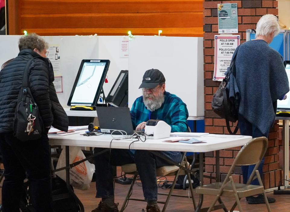 An election worker checks in a voter at a voting site in south Reno, Nevada, during the Feb. 6, 2024 presidential preference primary.