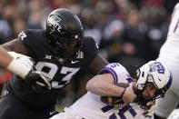 TCU quarterback Max Duggan (15) is sacked by Iowa State defensive tackle Isaiah Lee (93) during the first half an NCAA college football game, Friday, Nov. 26, 2021, in Ames, Iowa. (AP Photo/Charlie Neibergall)