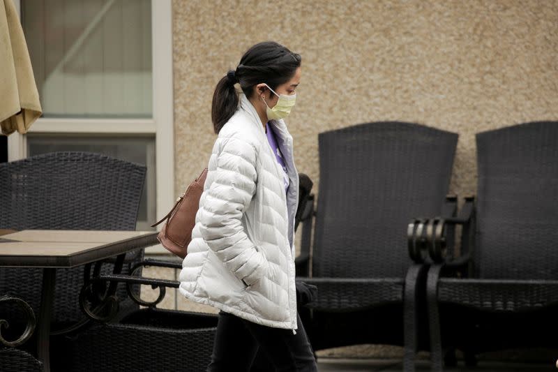 People are seen at the Life Care Center of Kirkland, the long-term care facility linked to several confirmed coronavirus cases, in Kirkland