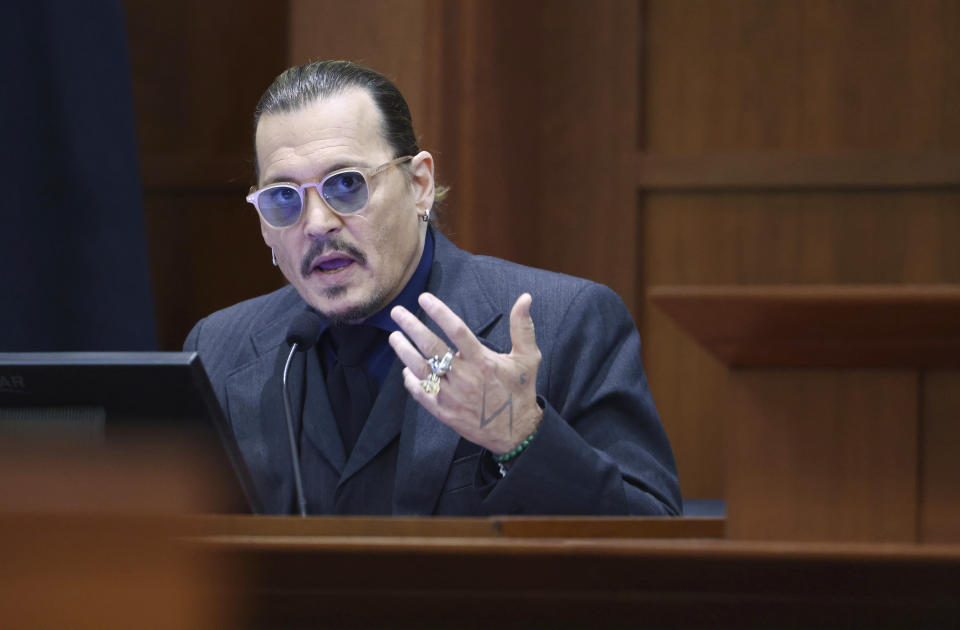 Actor Johnny Depp testifies in the courtroom at the Fairfax County Circuit Court in Fairfax, Va., Thursday, April 21, 2022. Actor Johnny Depp sued his ex-wife Amber Heard for libel in Fairfax County Circuit Court after she wrote an op-ed piece in The Washington Post in 2018 referring to herself as a "public figure representing domestic abuse." (Jim Lo Scalzo/Pool Photo via AP)