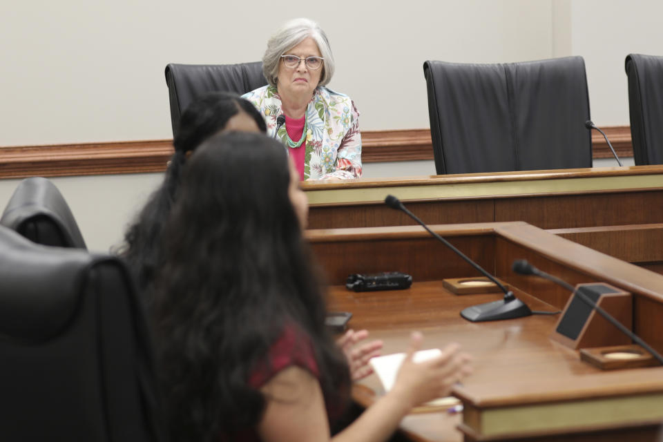 South Carolina Sen. Katrina Shealy, R-Lexington, listens to University of South Carolina student Anusha Ghosh testify at a Senate Finance subcommittee hearing on whether to eliminate sales tax on feminine hygiene products on Wednesday, April 17, 2024, in Columbia, S.C. (AP Photo/Jeffrey Collins)