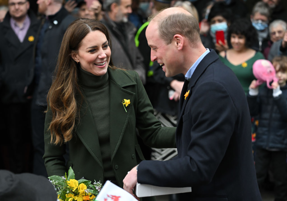 Kate Middleton and Prince William smiling at each other in Wales.