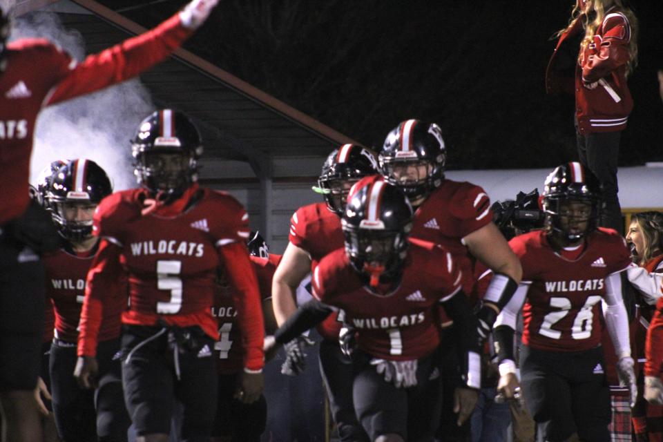 Baker County players charge onto the field before an FHSAA Region 1-5A football final against Wakulla on November 26, 2021. [Clayton Freeman/Florida Times-Union]