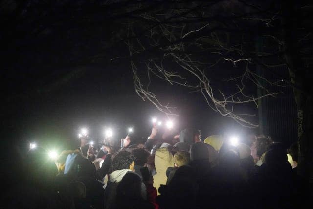 People take part in a vigil in Downhills Park in the West Green area of Haringey, London, for Harry