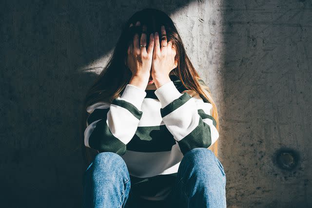 <p>Getty</p> Stock image of exasperated woman crying with hands over her face